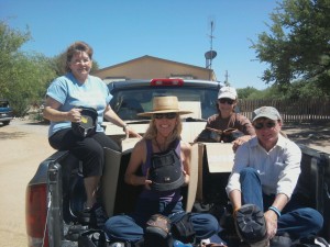 Nancy Fredrick of EasyCare Inc, Diane, Jean and Karen sitting in the midst of an assorment of EasyBoots